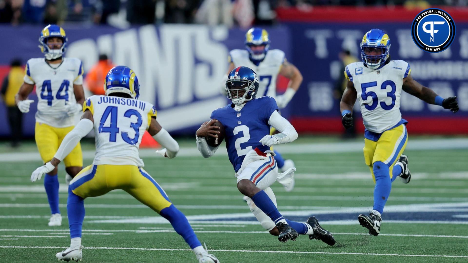 New York Giants quarterback Tyrod Taylor (2) runs with the ball against Los Angeles Rams safety John Johnson III (43) and cornerback Ahkello Witherspoon (44) and linebacker Ernest Jones (53) during the fourth quarter at MetLife Stadium.