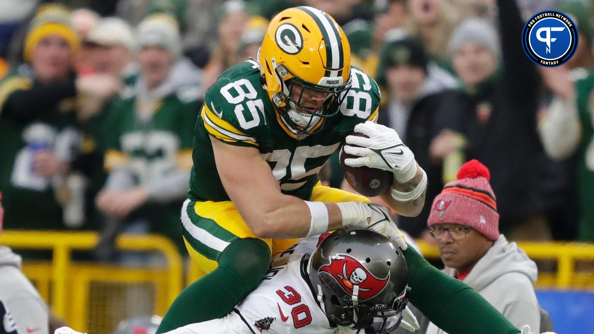 Packers tight end Tucker Kraft hurdles Buccaneers cornerback Dee Delaney while picking up a first down on a reception on December 17 at Lambeau Field.