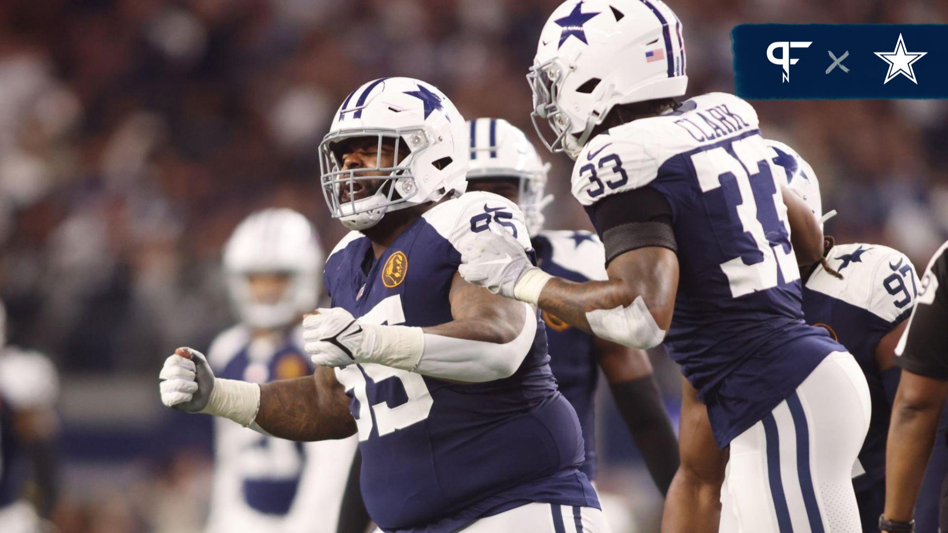 Dallas Cowboys defensive tackle Johnathan Hankins (95) and linebacker Damone Clark (33) celebrate a sack in the fourth quarter against the Washington Commanders at AT&T Stadium.