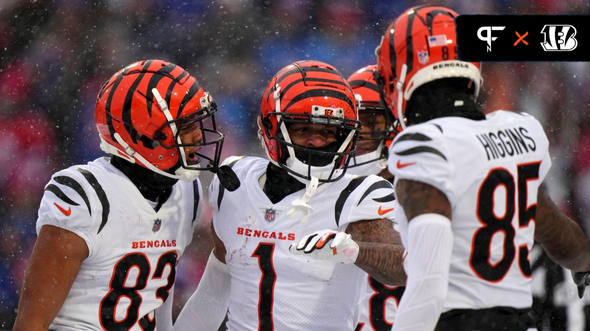 Cincinnati Bengals wide receiver Ja'Marr Chase (1), center, is congratulated by Cincinnati Bengals wide receiver Tyler Boyd (83), Cincinnati Bengals running back Joe Mixon (28) and Cincinnati Bengals wide receiver Tee Higgins (85) after a touchdown catch in the first quarter during an NFL divisional playoff football game between the Cincinnati Bengals and the Buffalo Bills, Sunday, Jan. 22, 2023, at Highmark Stadium in Orchard Park, N.Y. Cincinnati Bengals At Buffalo Bills Afc Divisional Jan 22 0190