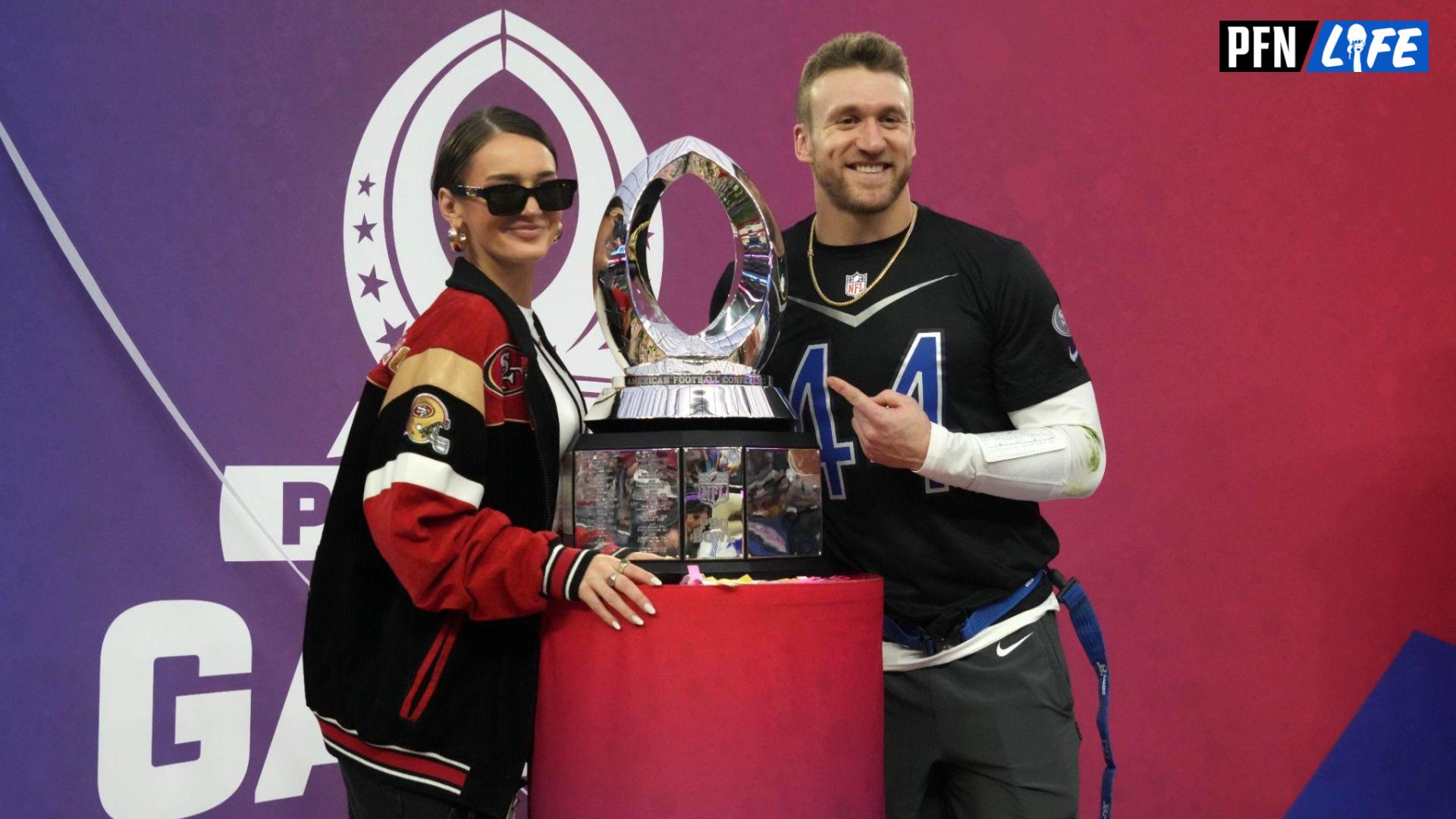 NFC fullback Kyle Juszczyk of the San Francisco 49ers (44) and wife Kristin Juszcyk pose with trophy during the Pro Bowl Games at Allegiant Stadium.