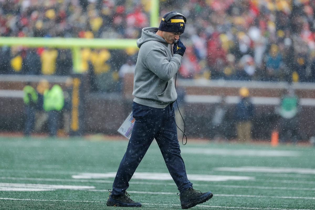 Michigan defensive coordinator Mike Macdonald walks off the field after the timeout during the first half against Ohio State at Michigan Stadium in Ann Arbor on Saturday, Nov. 27, 2021.