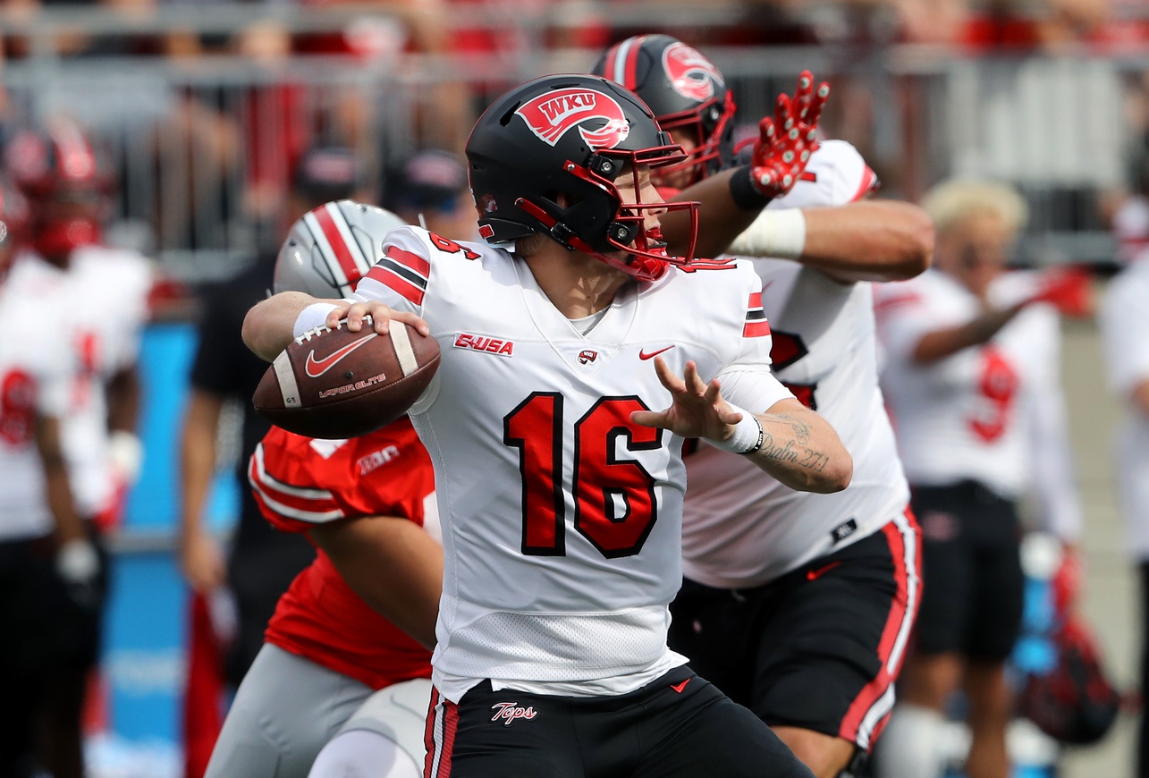 Western Kentucky Hilltoppers quarterback Austin Reed (16) drops to throw during the first quarter against the Ohio State Buckeyes at Ohio Stadium.