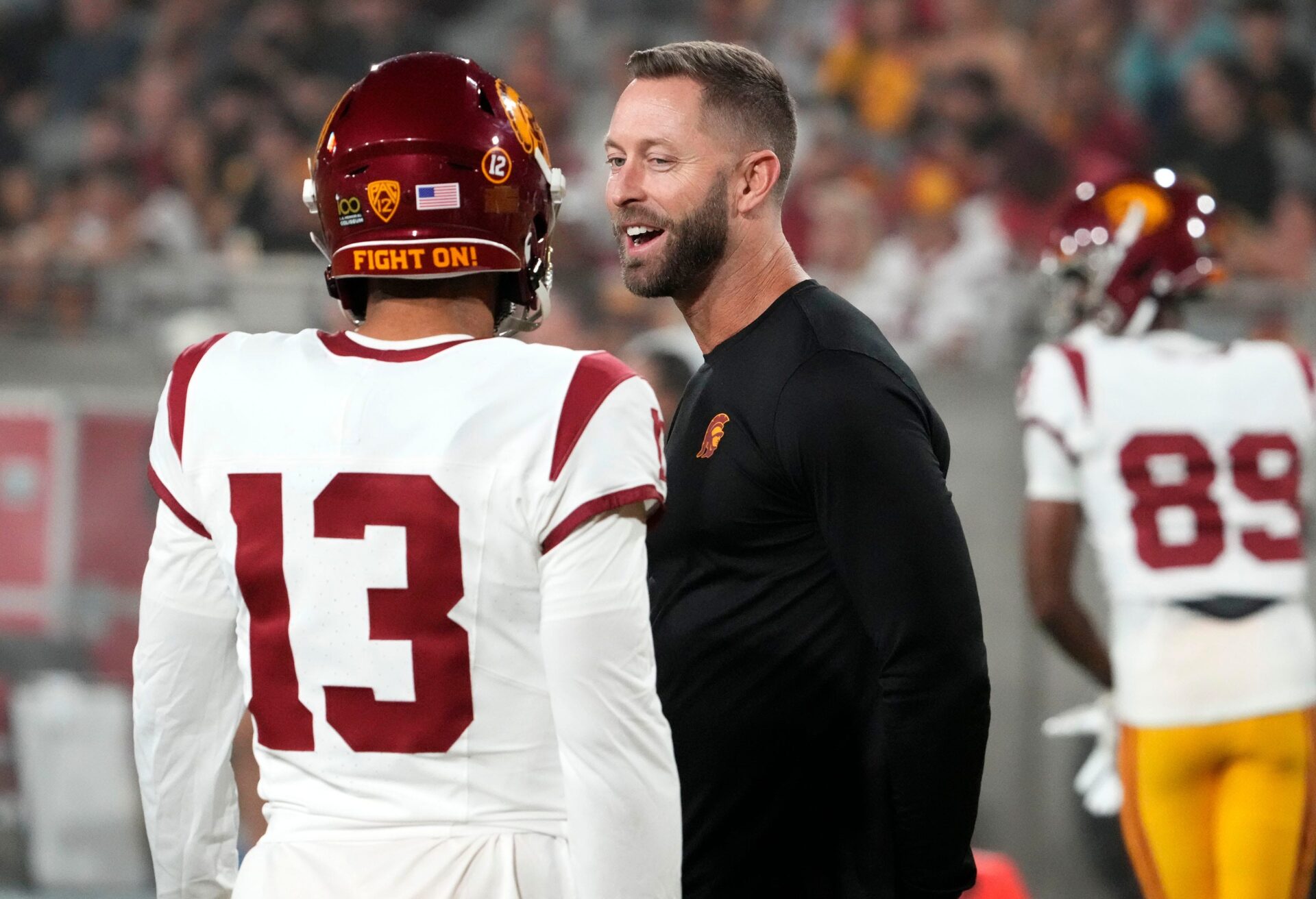The former Arizona Cardinals head coach and now USC Trojans assistant coach Kliff Kingsbury talks to quarterback Caleb Williams (13) during the pregame warmup before playing the Arizona State Sun Devils