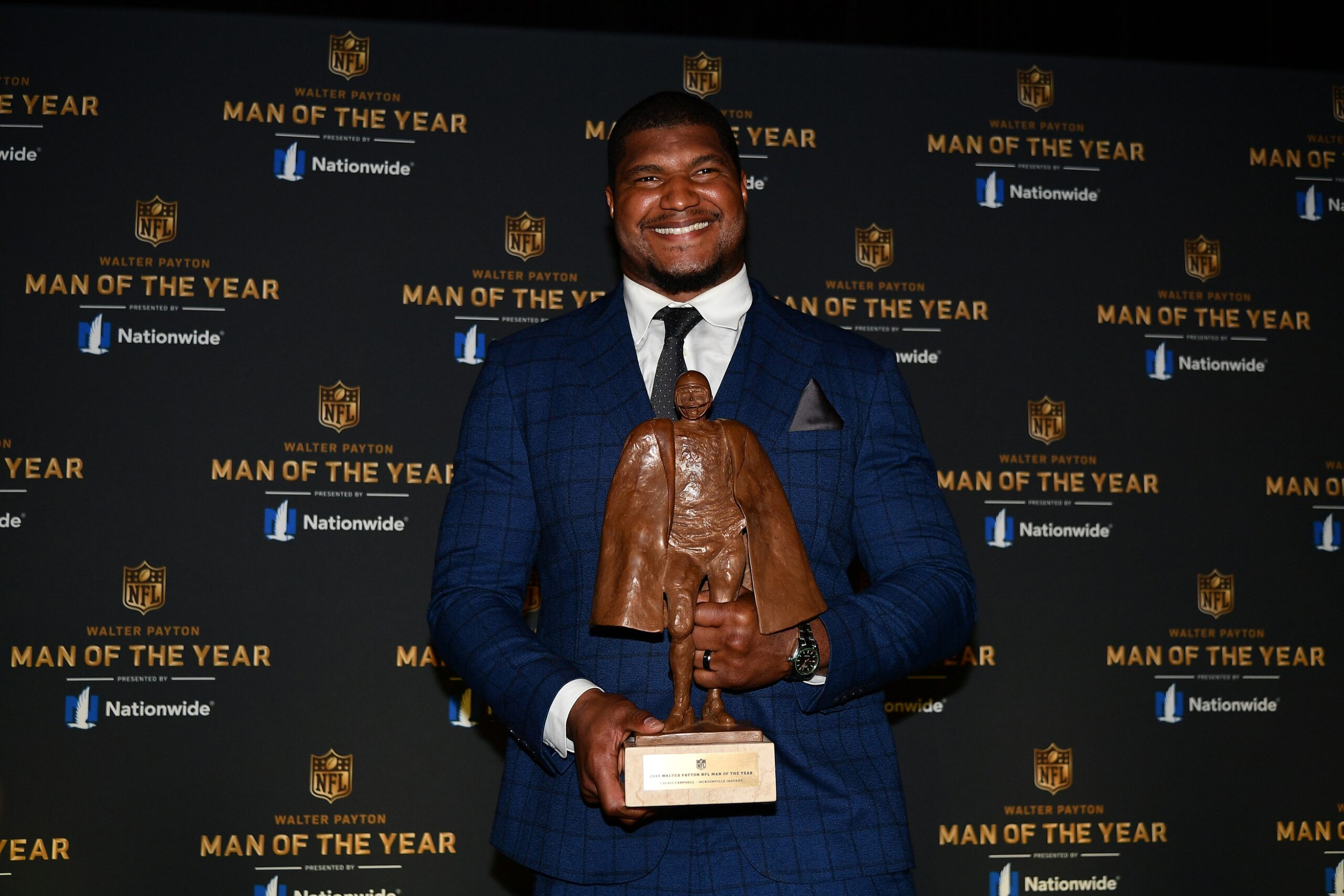 Jacksonville Jaguars Calais Campbell poses for pictures with the Walter Payton NFL Man of the Year Award in 2020.