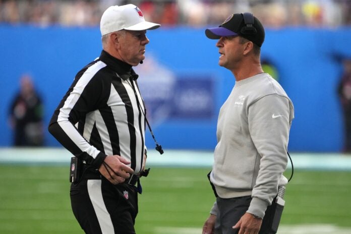 Baltimore Ravens head coach John Harbaugh (right) talks with referee Bill Vinovich (52) in the first half against the Tennessee Titans during an NFL International Series game at Tottenham Hotspur Stadium.
