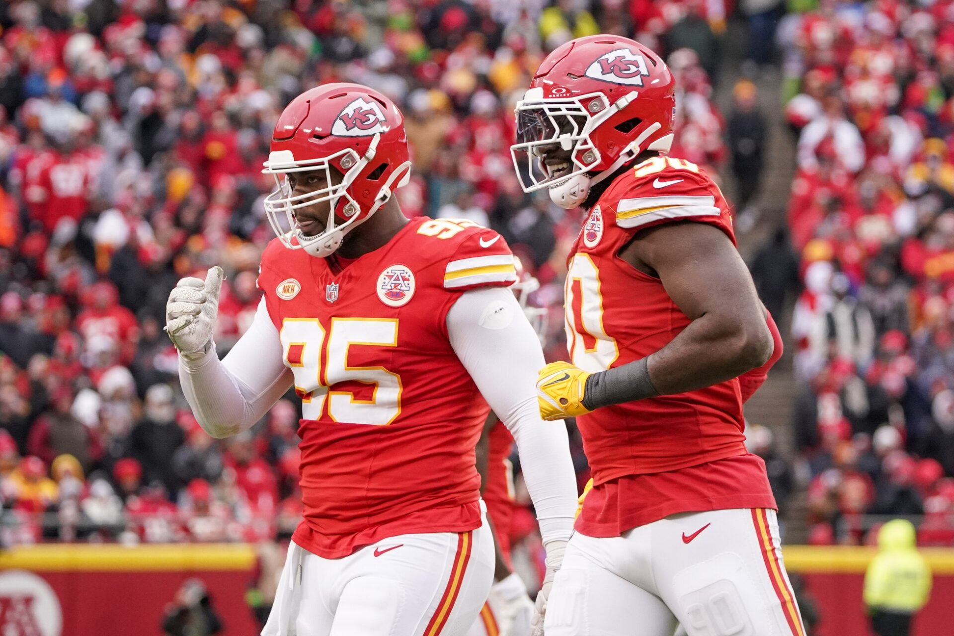 Kansas City Chiefs defensive end Charles Omenihu (90) celebrates with defensive tackle Chris Jones (95) after a play against the Las Vegas Raiders during the game at GEHA Field at Arrowhead Stadium.