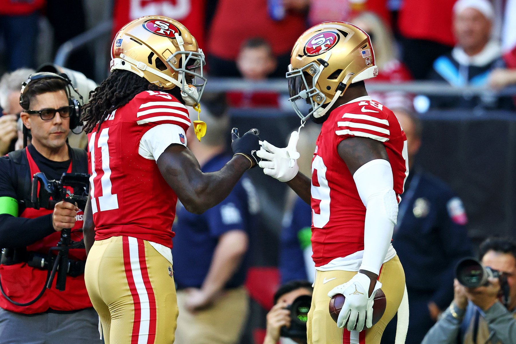 San Francisco 49ers wide receiver Deebo Samuel (19) celebrates with wide receiver Brandon Aiyuk (11) after scoring a touchdown during the first quarter against the Arizona Cardinals at State Farm Stadium.