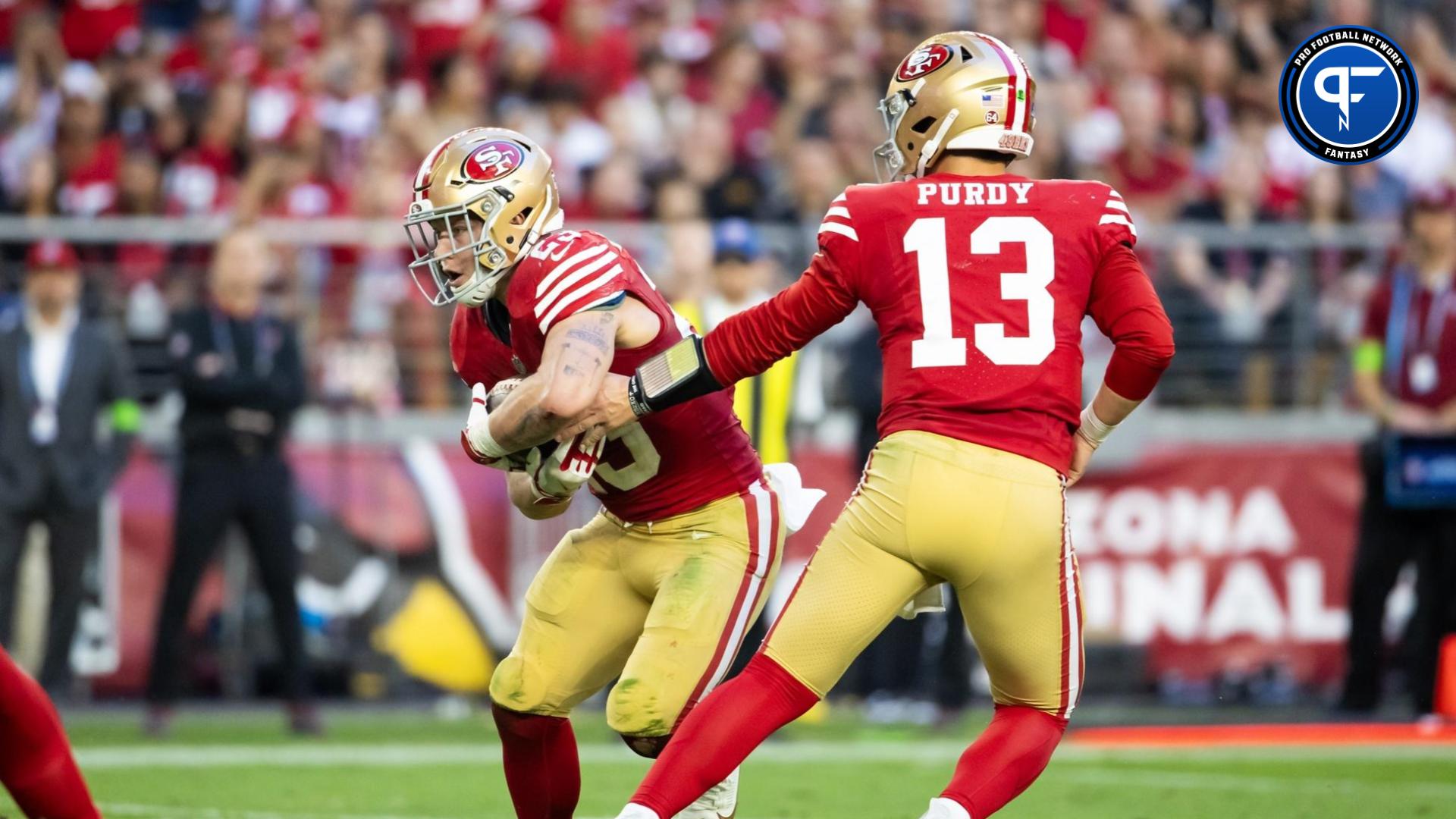 San Francisco 49ers quarterback Brock Purdy (13) hands off the ball to running back Christian McCaffrey (23) against the Arizona Cardinals at State Farm Stadium.