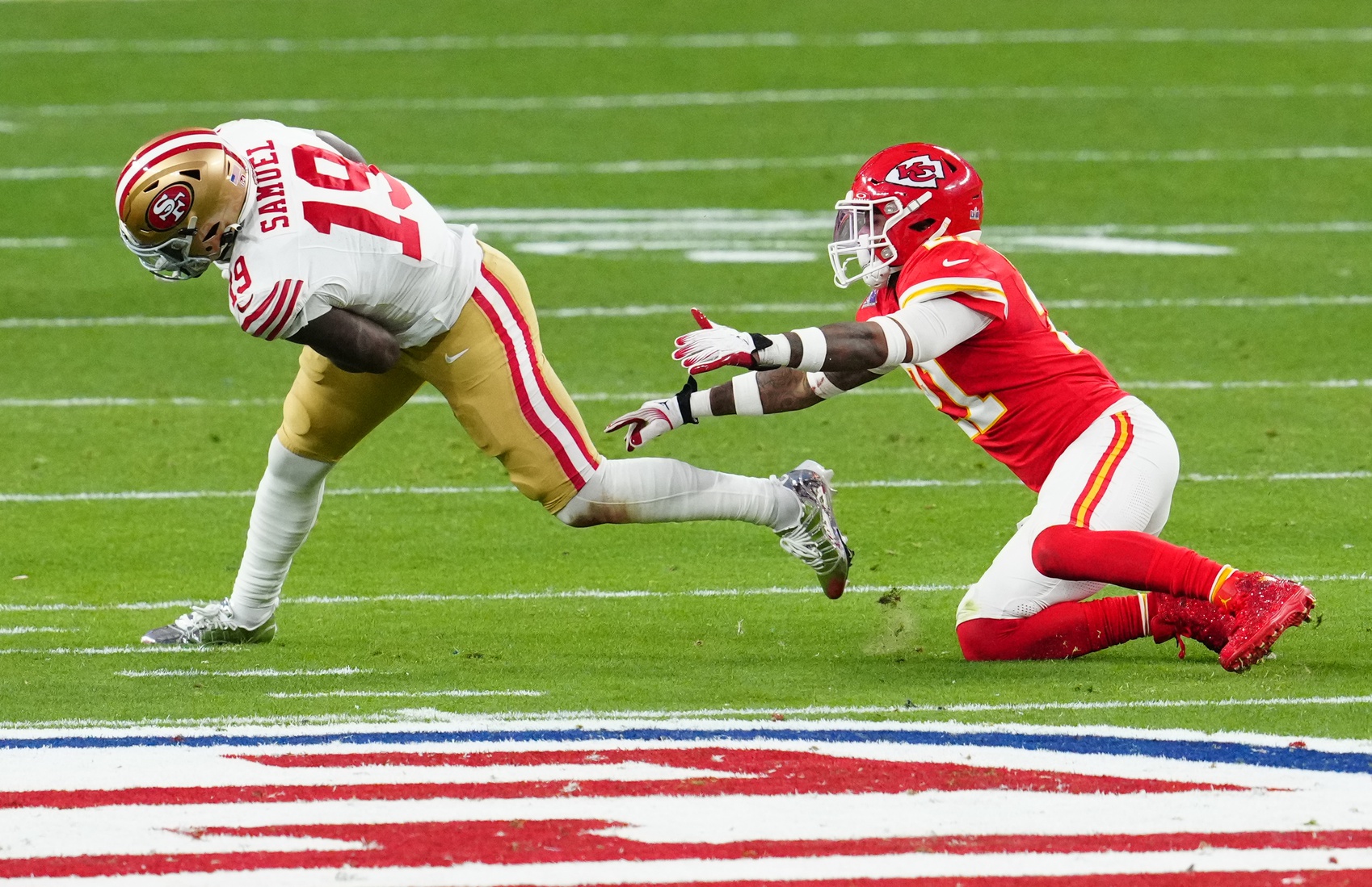 San Francisco 49ers wide receiver Deebo Samuel (19) gets away from Kansas City Chiefs safety Mike Edwards (21) in the first half in Super Bowl LVIII at Allegiant Stadium.
