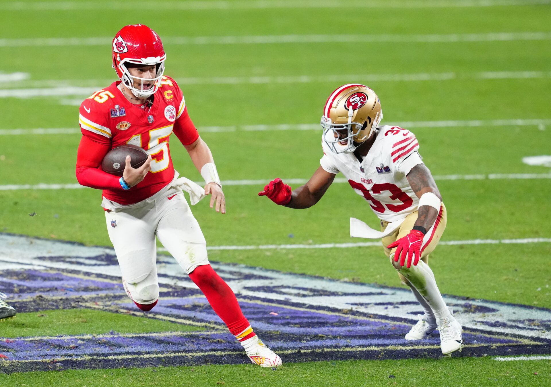 Kansas City Chiefs quarterback Patrick Mahomes (15) runs against San Francisco 49ers safety Logan Ryan (33) during overtime in Super Bowl LVIII at Allegiant Stadium.