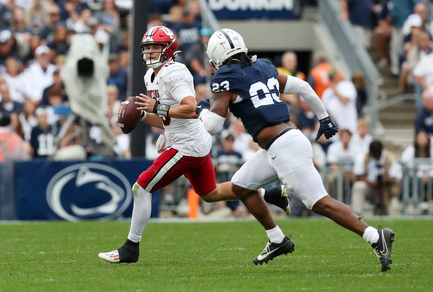 Indiana Hoosiers quarterback Brendan Sorsby (15) runs with the ball under pressure from Penn State Nittany Lions linebacker Curtis Jacobs (23) during the fourth quarter at Beaver Stadium.