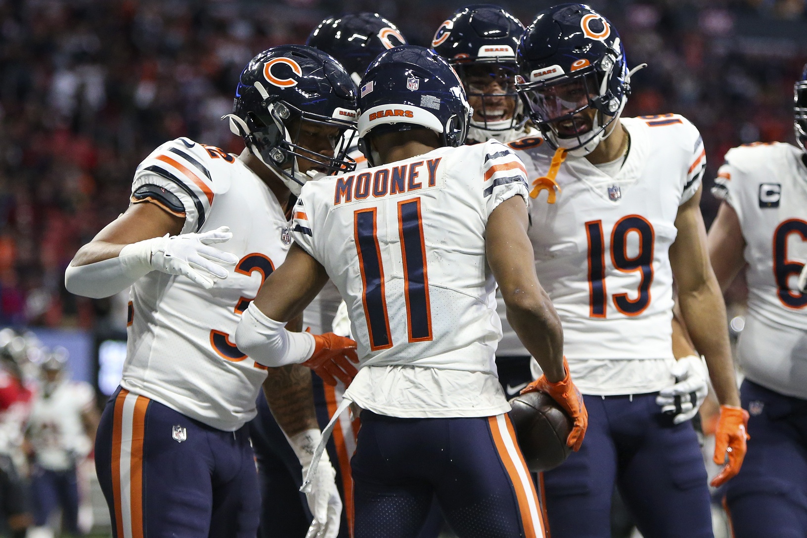 Chicago Bears wide receiver Darnell Mooney (11) celebrates with teammates after a touchdown catch against the Atlanta Falcons in the first quarter at Mercedes-Benz Stadium.