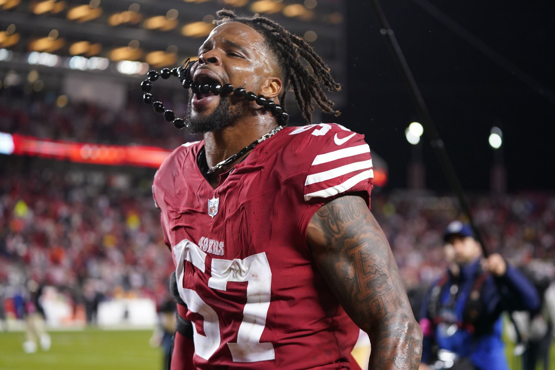 San Francisco 49ers linebacker Dre Greenlaw (57) celebrates after defeating the Green Bay Packers in a 2024 NFC divisional round game at Levi's Stadium.