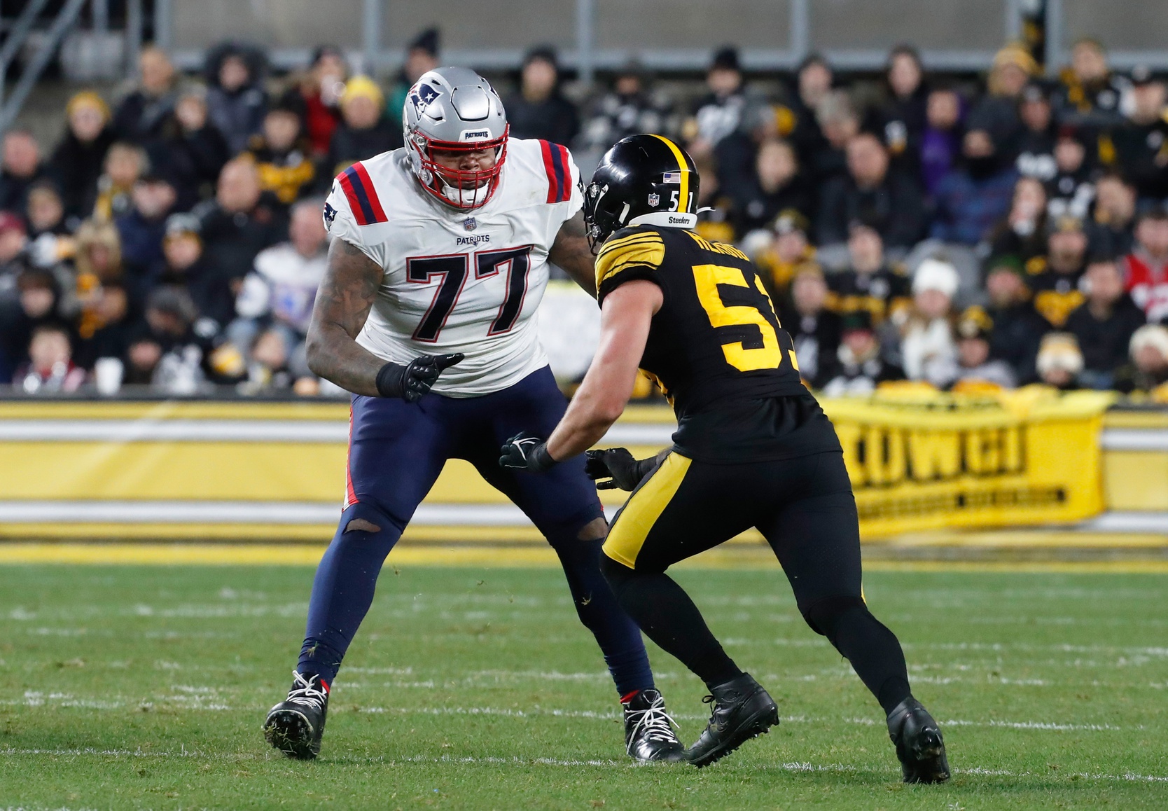 New England Patriots offensive tackle Trent Brown (77) blocks against Pittsburgh Steelers linebacker Nick Herbig (51) during the third quarter at Acrisure Stadium.