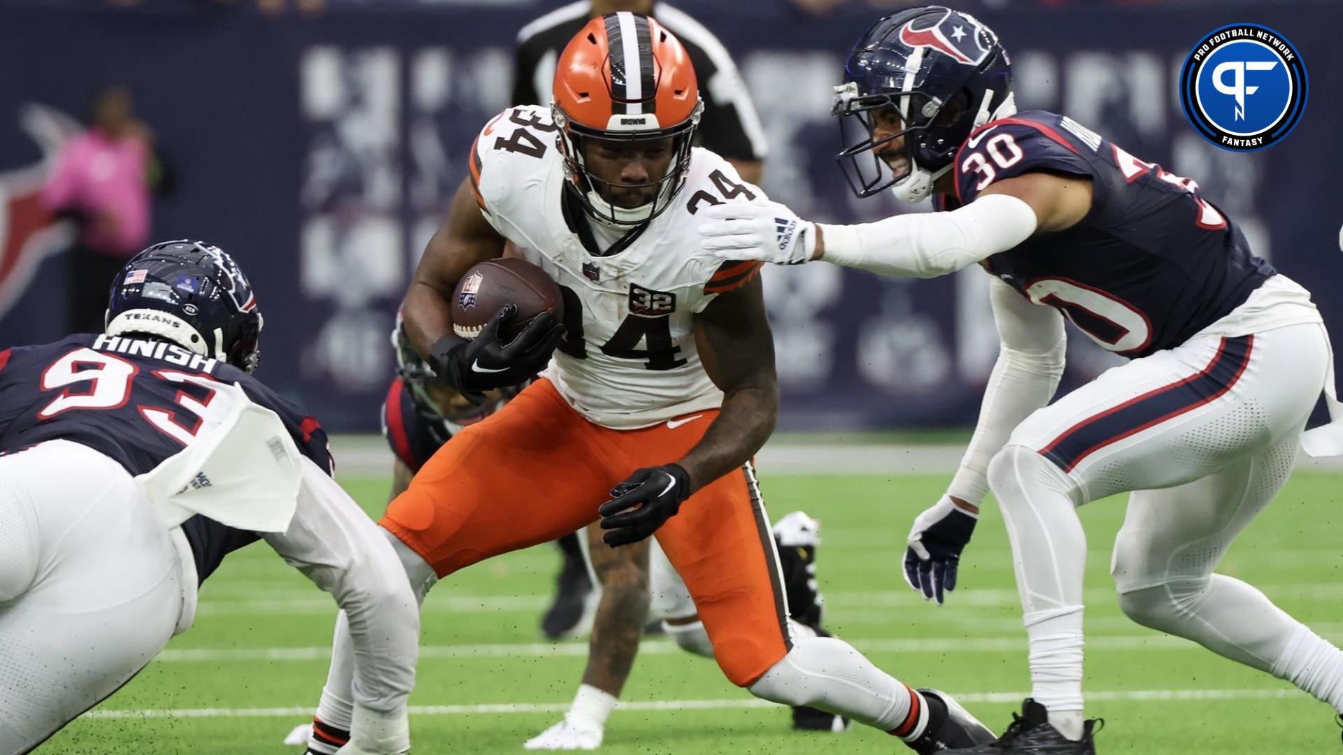 Cleveland Browns running back Jerome Ford (34) rushes against Houston Texans safety DeAndre Houston-Carson (30) in the second half at NRG Stadium.