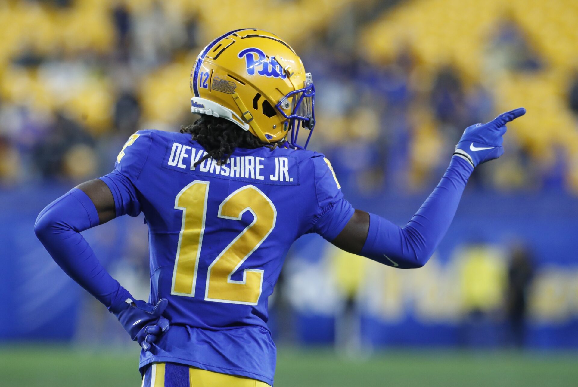 Pittsburgh Panthers DB M.J. Devonshire (12) gestures towards the opponent's bench during a game.