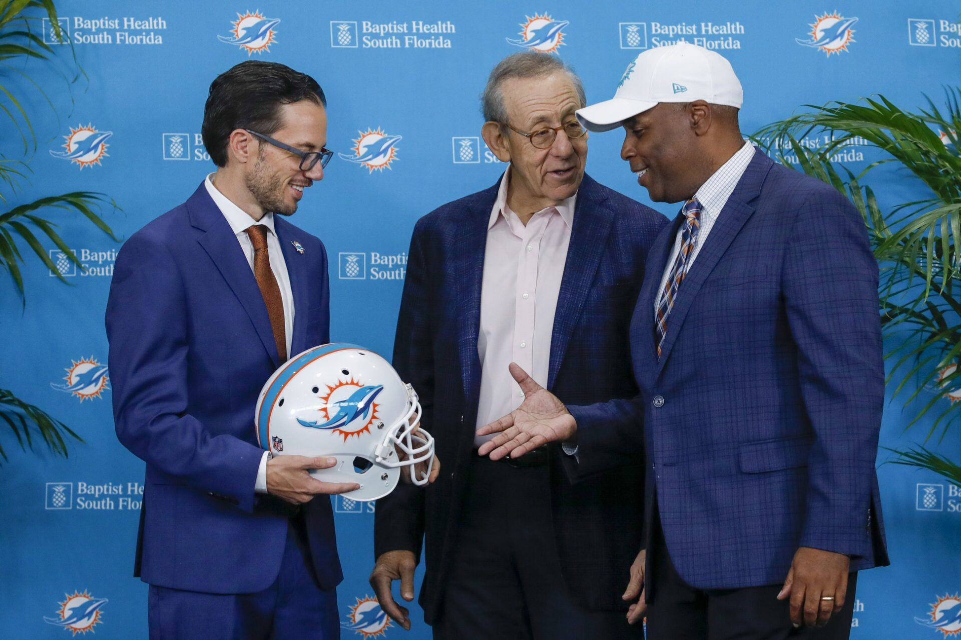 Miami Dolphins head coach Mike McDaniel, shakes hands with general manager Chris Grier and owner Stephen M. Ross after a press conference at Baptist Health Training Center.