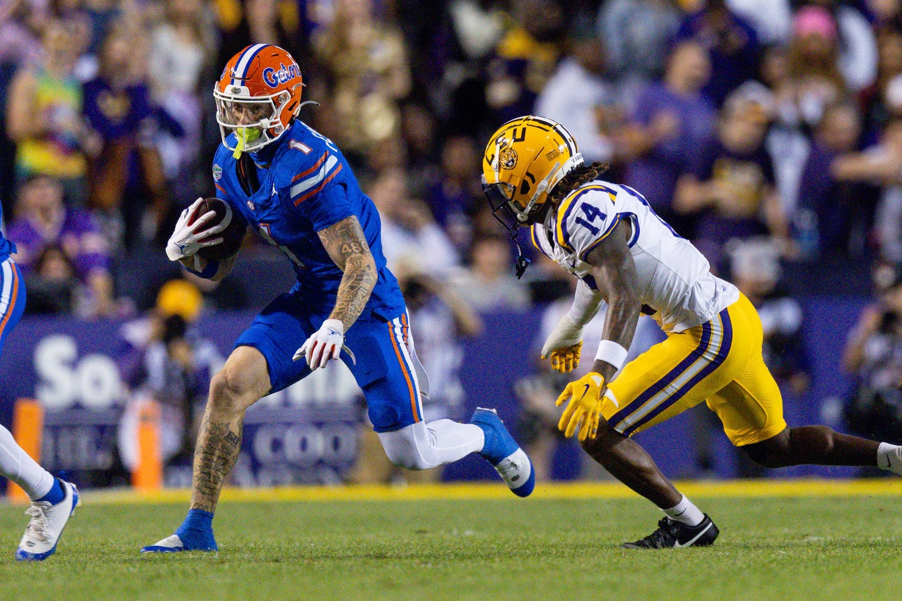 Florida Gators wide receiver Ricky Pearsall (1) catches a pass against LSU Tigers safety Andre' Sam (14) during the first half at Tiger Stadium.