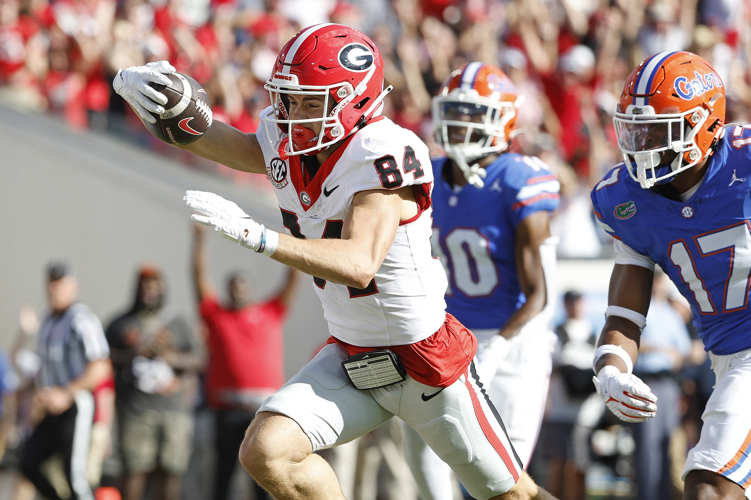 Georgia Bulldogs wide receiver Ladd McConkey (84) stretches for a touchdown past Florida Gators linebacker Scooby Williams (17) in the first half at EverBank Stadium.