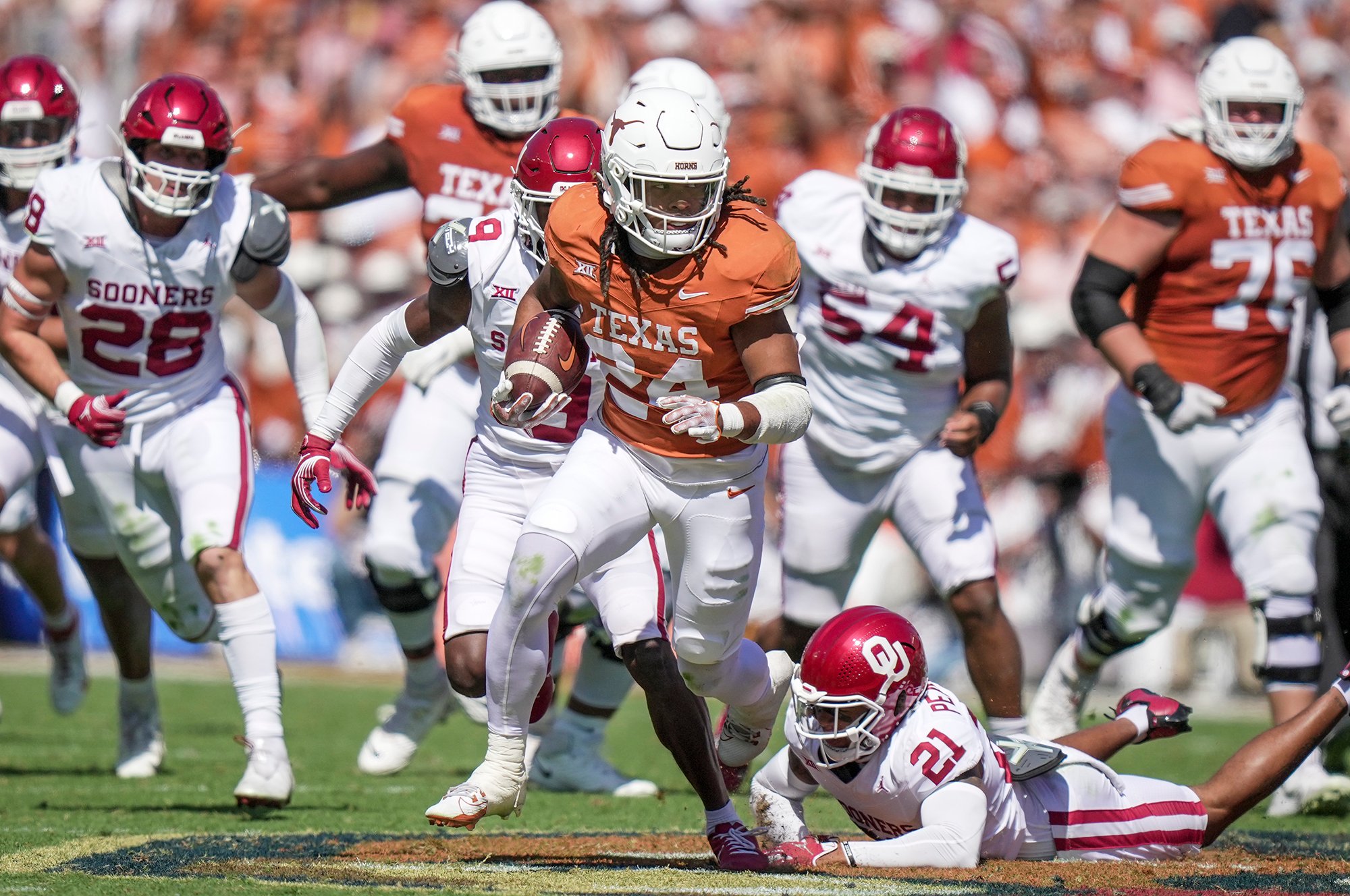 Texas Longhorns running back Jonathon Brooks (24) picks up a first down against the Oklahoma Sooners in the third quarter at the Cotton Bowl.
