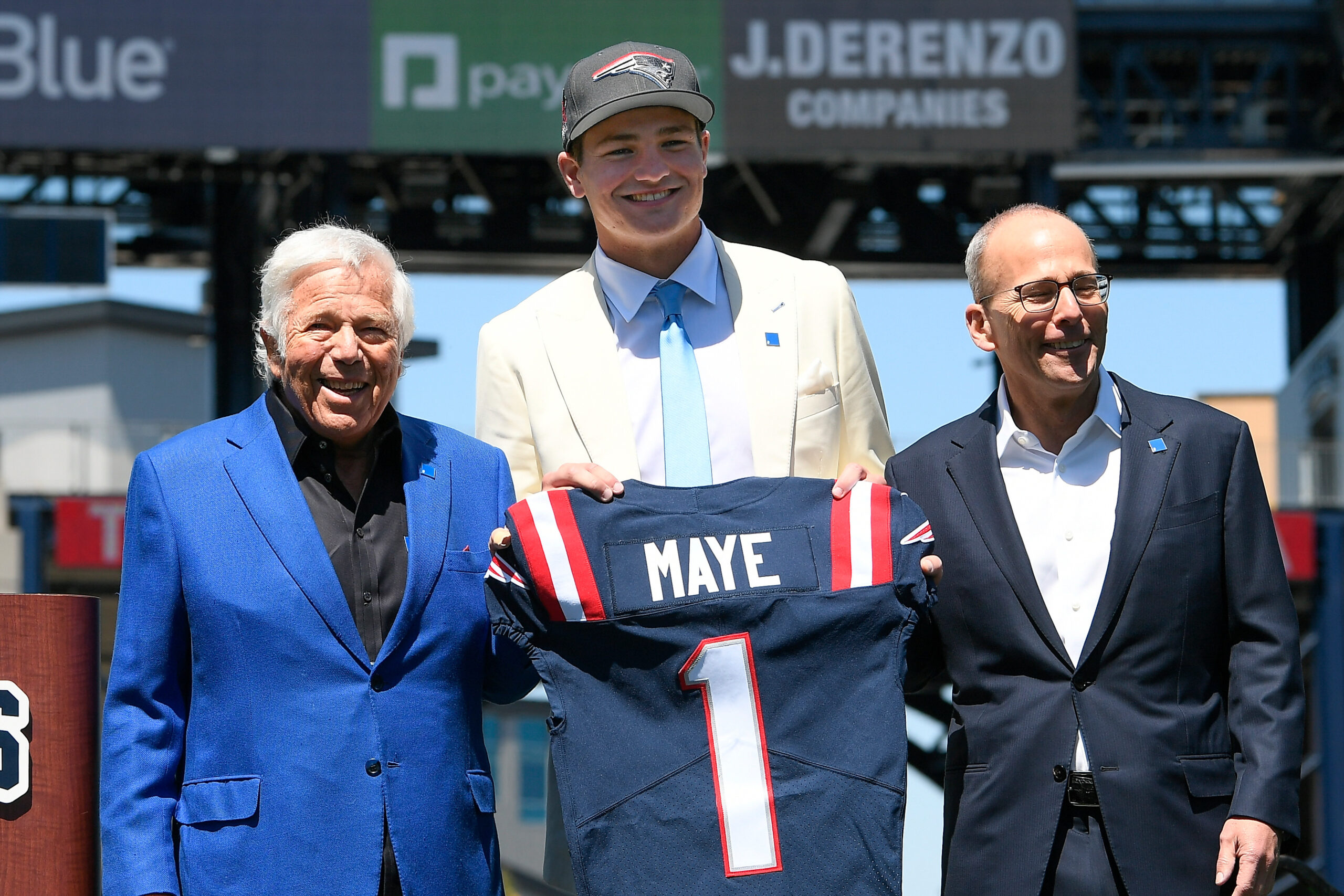 New England Patriots owner (L) Robert Kraft and president Jonathan Kraft (R) introduce the team's first round draft pick quarterback Drake Maye (C) on the game field at Gillette Stadium.
