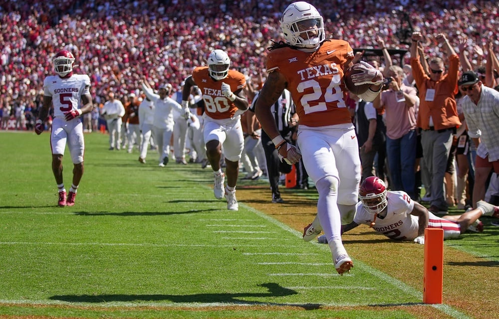 Oct 7, 2023; Dallas, Texas, USA; Texas Longhorns running back Jonathon Brooks (24) scores a touchdown against the Oklahoma Sooners in the fourth quarter at the Cotton Bowl. This game makes up the 119th rivalry match up. Mandatory Credit: Ricardo B. Brazziell-USA TODAY Sports