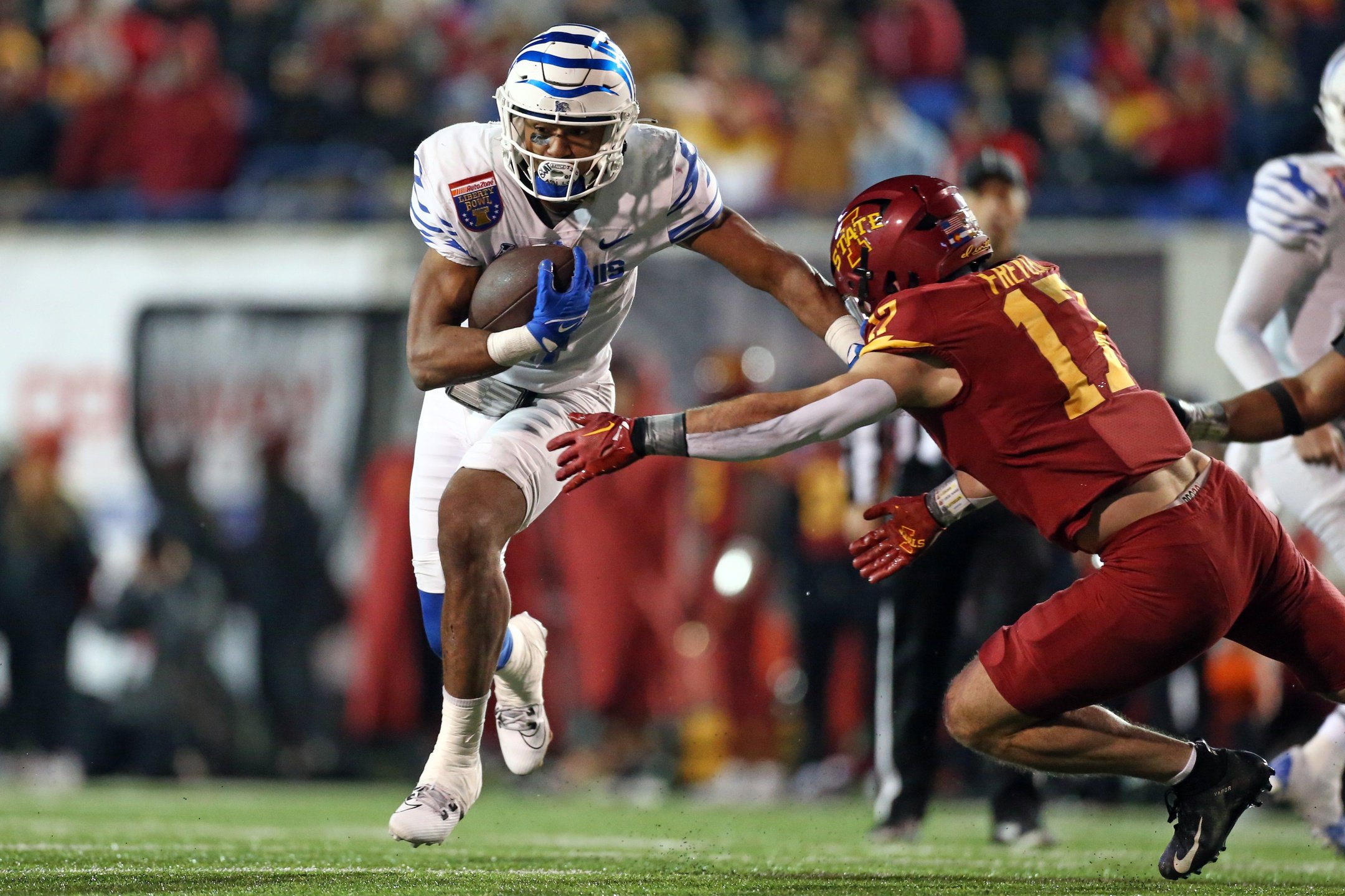 Memphis Tigers running back Blake Watson (4) runs the ball as Iowa State Cyclones defensive back Beau Freyler (17) makes the tackle during the second half at Simmons Bank Liberty Stadium.