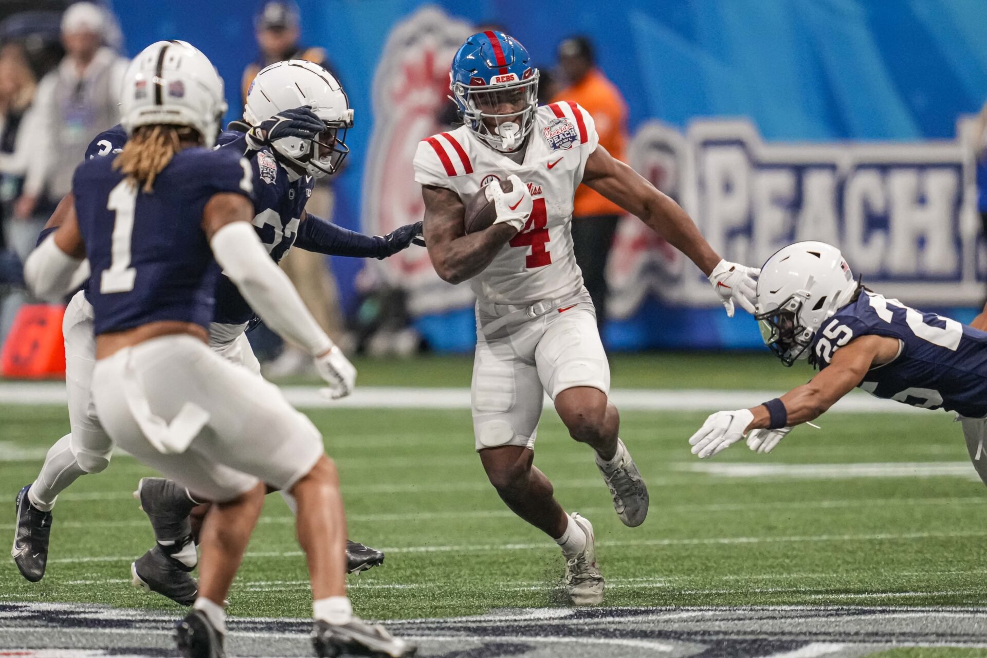Mississippi Rebels running back Quinshon Judkins (4) runs against the Penn State Nittany Lions during the second half at Mercedes-Benz Stadium.