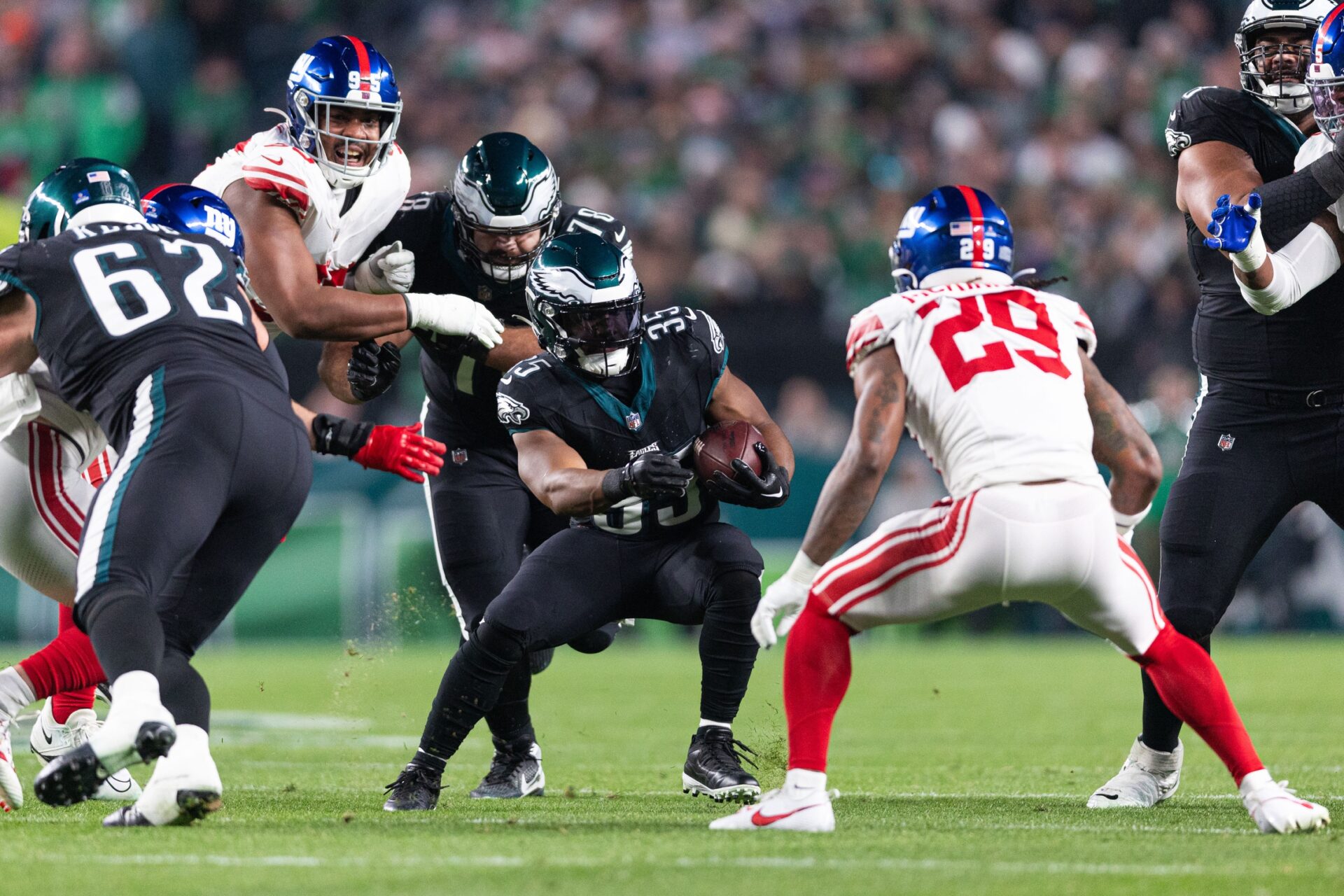 Philadelphia Eagles running back Boston Scott (35) and New York Giants safety Xavier McKinney (29) in action during the first quarter at Lincoln Financial Field.
