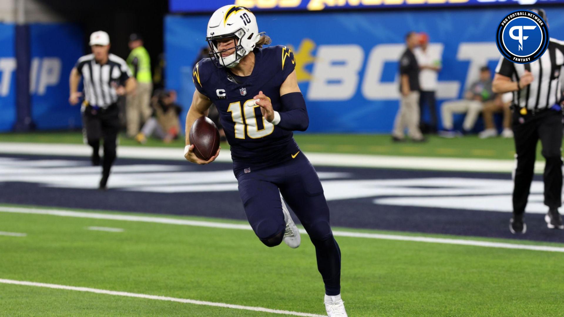 Los Angeles Chargers quarterback Justin Herbert (10) runs with a ball during the first quarter against the Baltimore Ravens at SoFi Stadium.