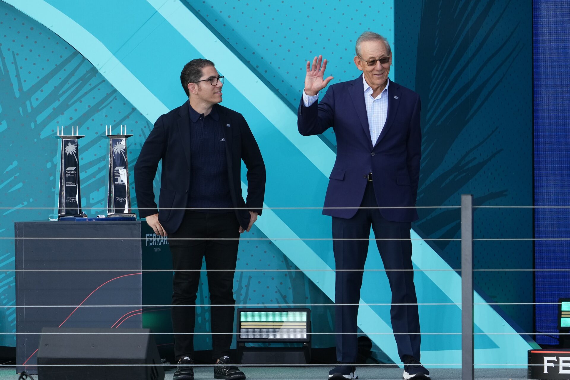 Miami Dolphins owner Stephen Ross waves from the podium of the Miami Grand Prix.