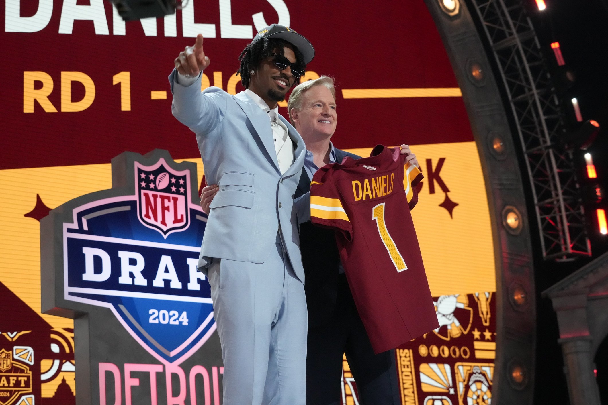 LSU Tigers quarterback Jayden Daniels poses with NFL commissioner Roger Goodell after being selected by the Washington Commanders as the No. 2 pick in the first round of the 2024 NFL Draft at Campus Martius Park and Hart Plaza. Mandatory Credit: Kirby Lee-USA TODAY Sports