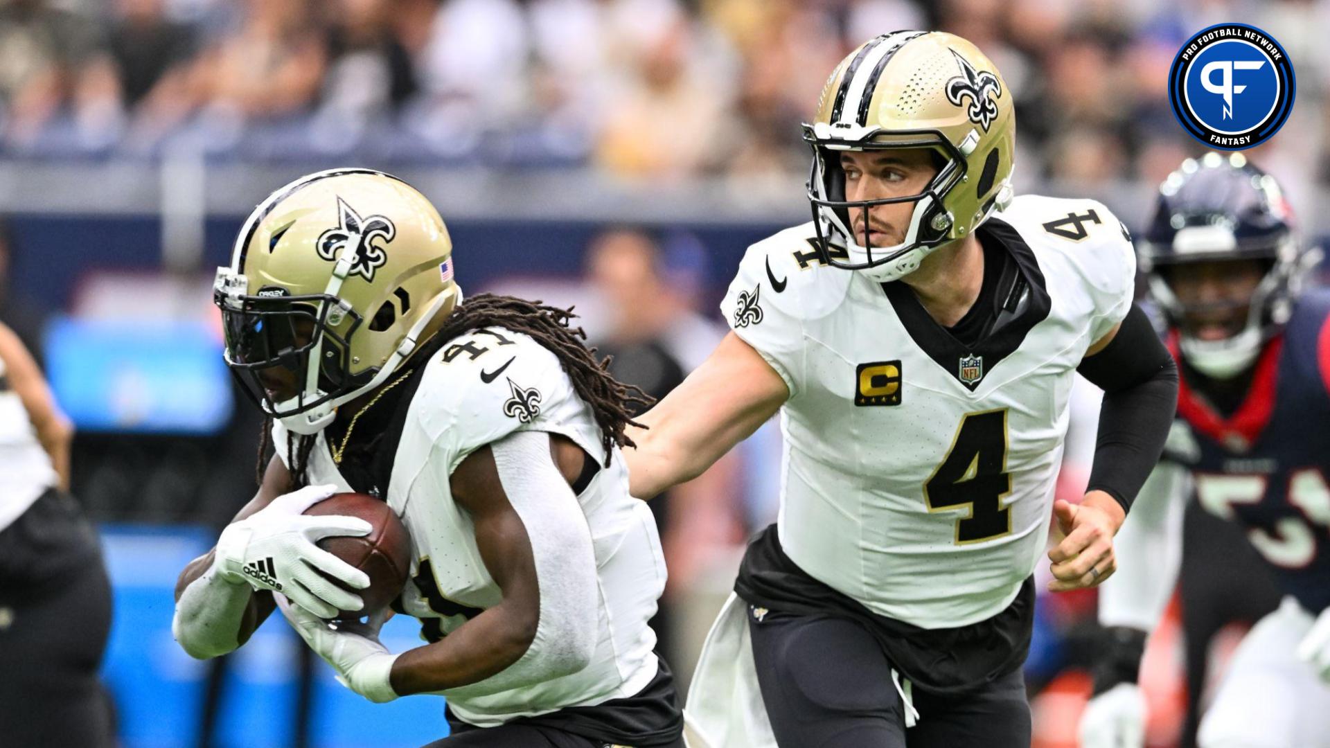 New Orleans Saints quarterback Derek Carr (4) hands off the ball to running back Alvin Kamara (41) during the first quarter against the Houston Texans at NRG Stadium.