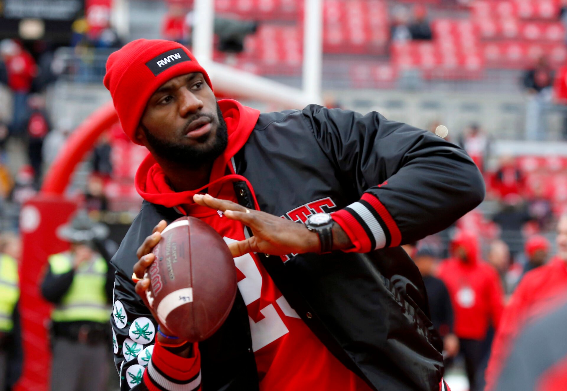 Cleveland Cavaliers player LeBron James plays catch with the Ohio State Buckeyes team before the game against the Michigan Wolverines at Ohio Stadium.