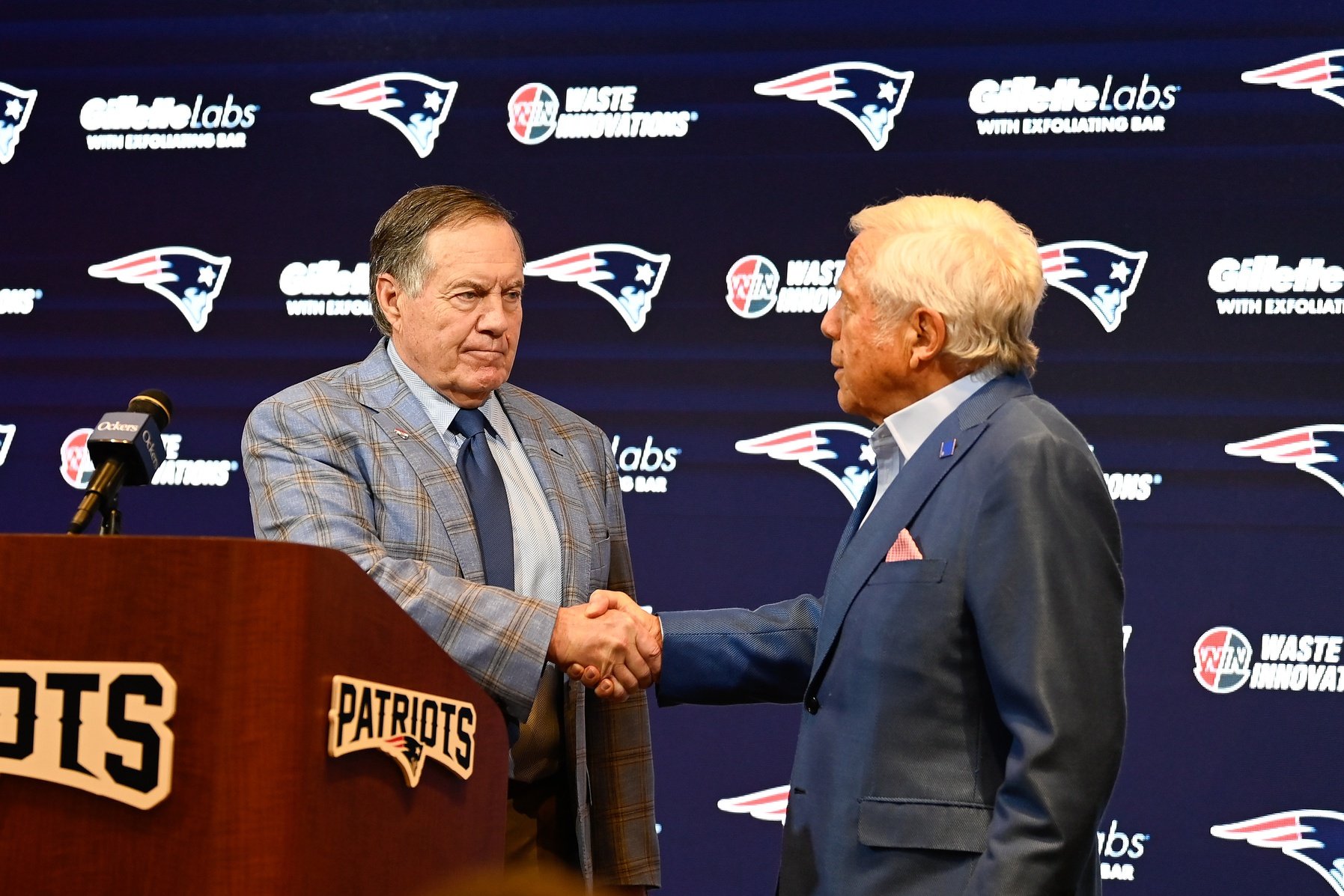 New England Patriots former head coach Bill Belichick (left) shakes hands with Patriots owner Robert Kraft (right) during a press conference at Gillette Stadium to announce Belichick's exit from the team. Mandatory Credit: Eric Canha-USA TODAY Sports