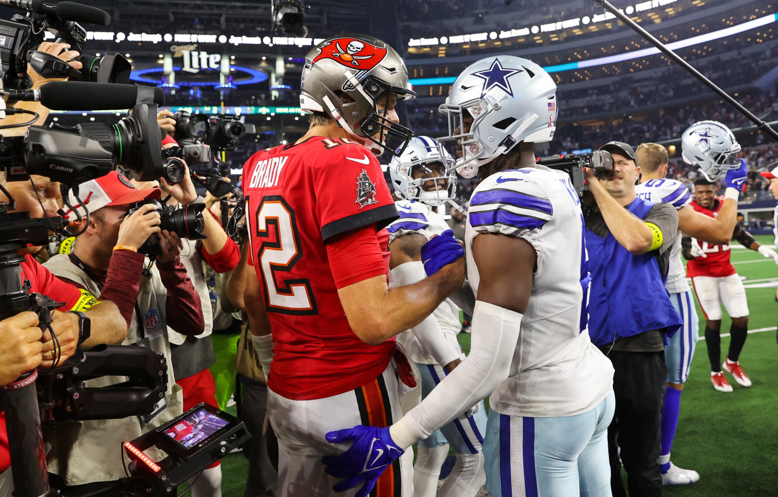 Tampa Bay Buccaneers quarterback Tom Brady (12) shakes hands with Dallas Cowboys safety Donovan Wilson (6) after the game at AT&T Stadium.