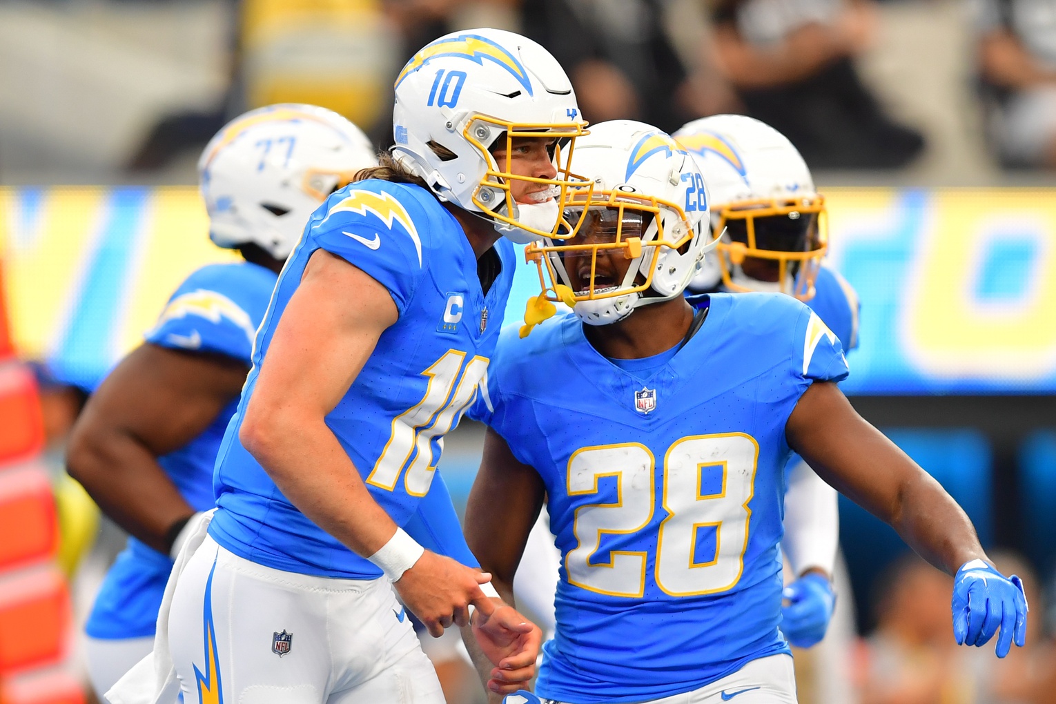 Los Angeles Chargers quarterback Justin Herbert (10) celebrates his touchdown scored against the Las Vegas Raiders with running back Isaiah Spiller (28) during the first half at SoFi Stadium. Mandatory Credit: Gary A. Vasquez-USA TODAY Sports